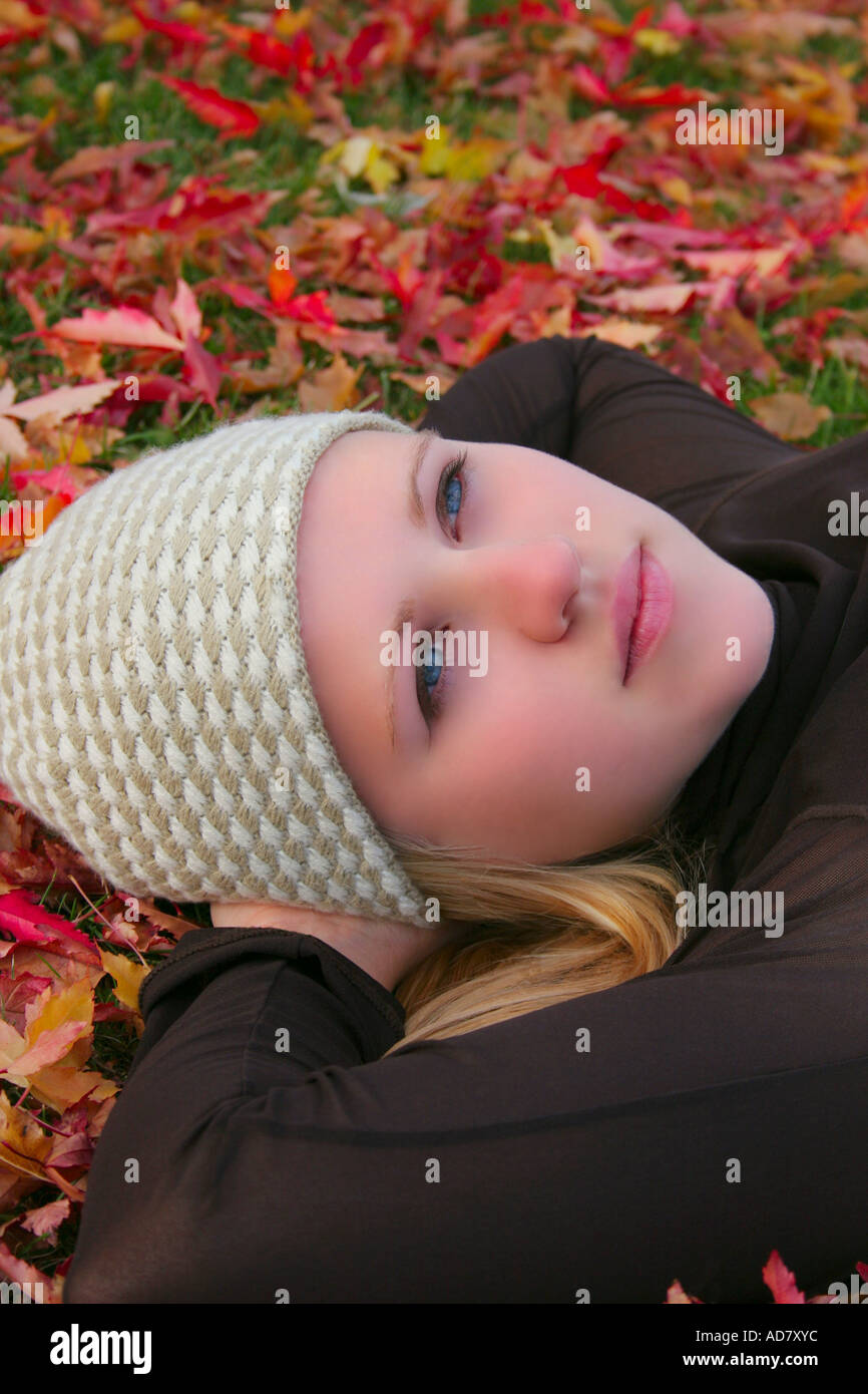Young woman laying back on grass Stock Photo - Alamy