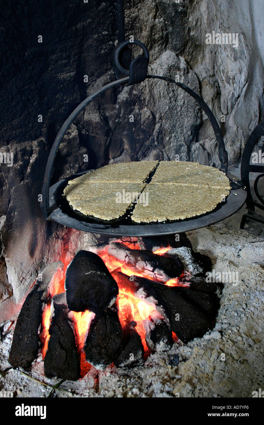 Oat cakes cooking over a peat fire Ulster Folk Museum Holywood Belfast Northern Ireland UK Stock Photo