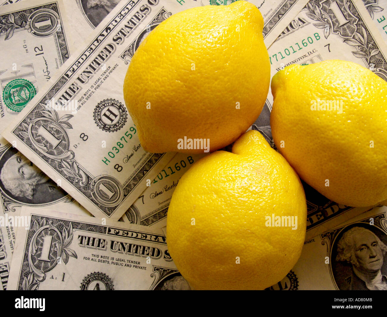 Fresh lemons in soft light against a background of dollar bills Stock Photo