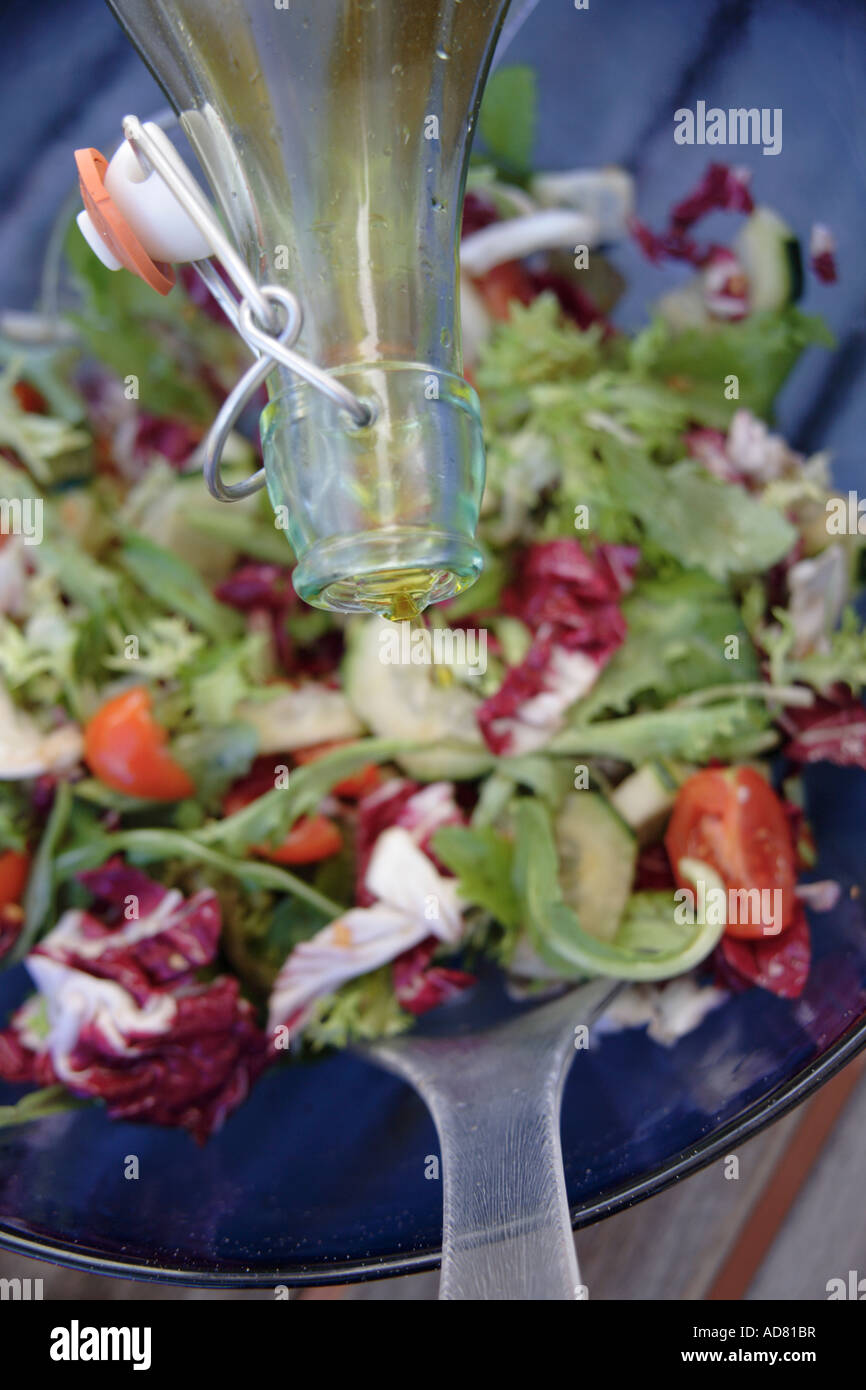 Adding Fresh Oil Preparing fresh salad: adding olive oil Stock Photo - Alamy