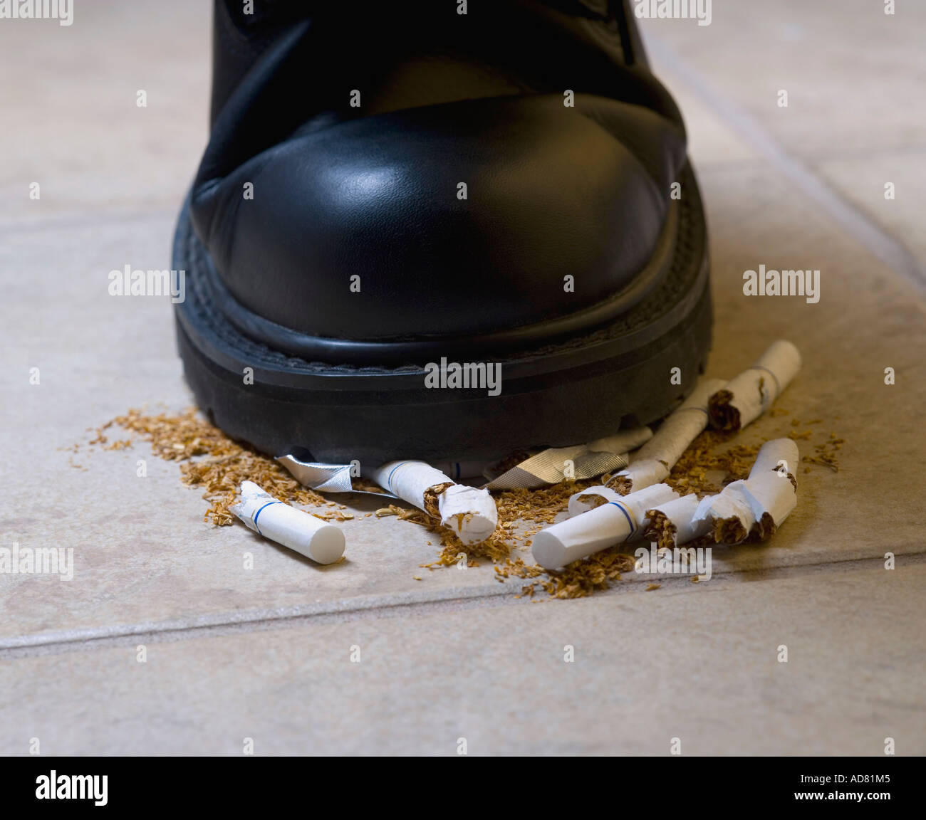 Shoe crushing cigarettes Stock Photo Alamy