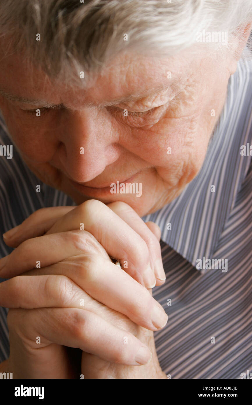 Senior woman praying Stock Photo