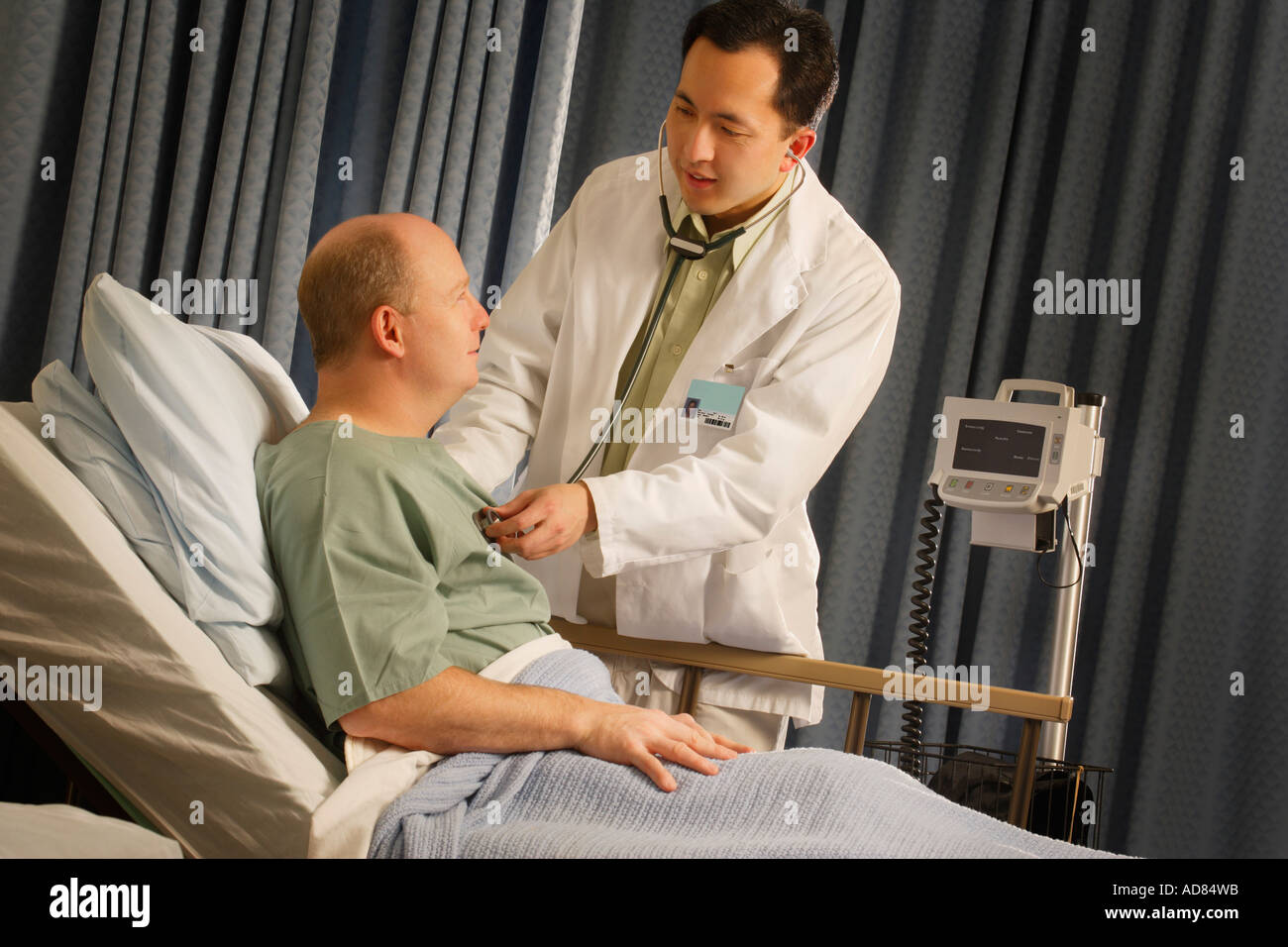 Doctor checking patient with a stethoscope Stock Photo