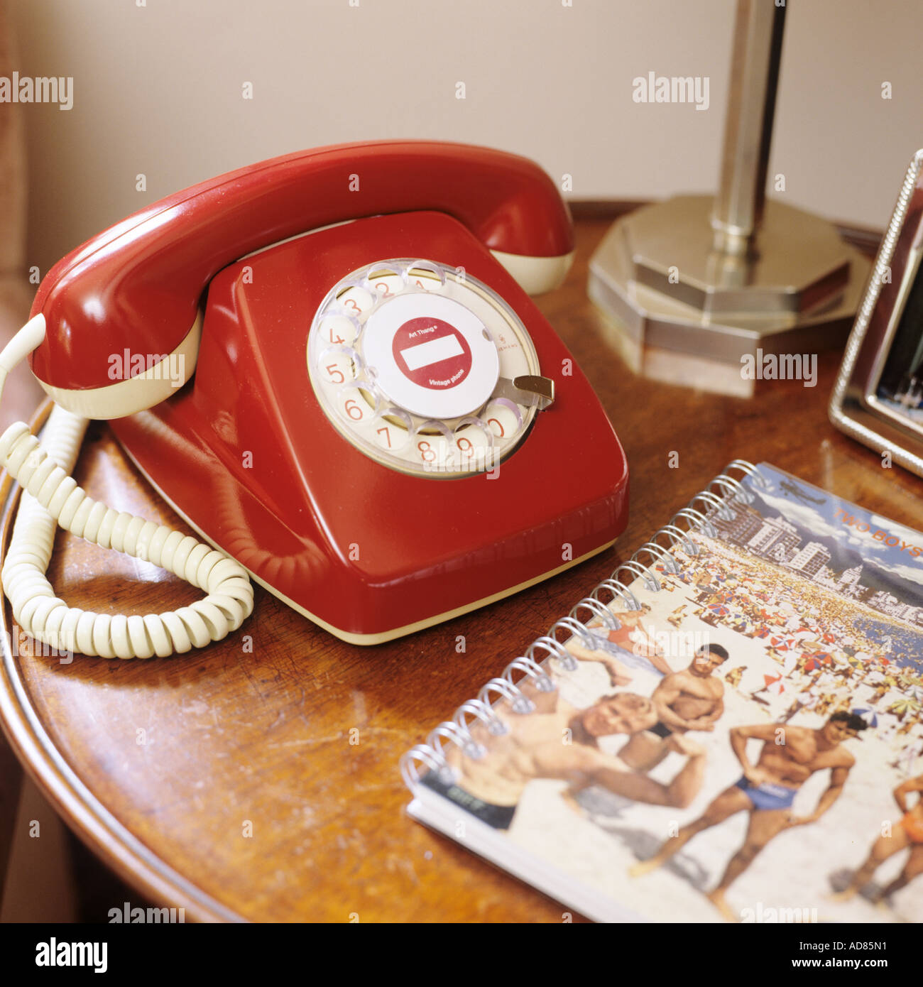 Vintage red telephone on wooden round table Stock Photo