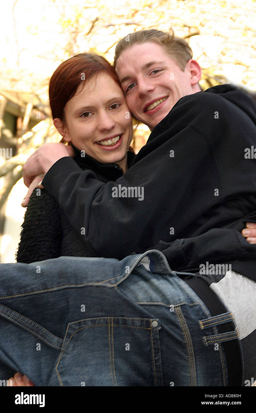a lady carries a man Stock Photo