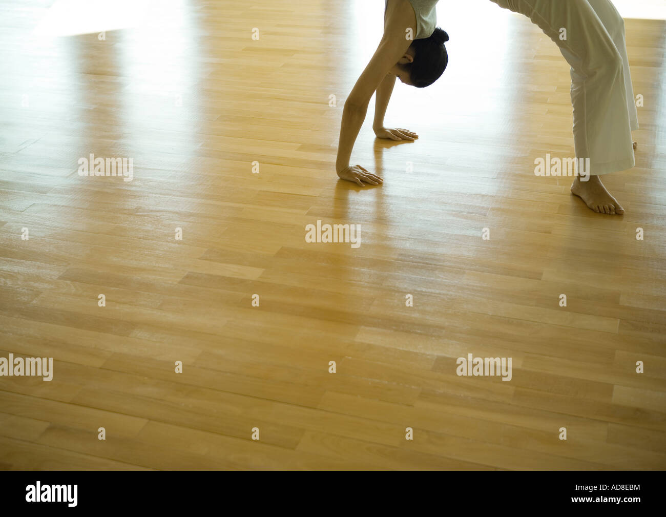 Woman doing bridge position, side view, cropped Stock Photo