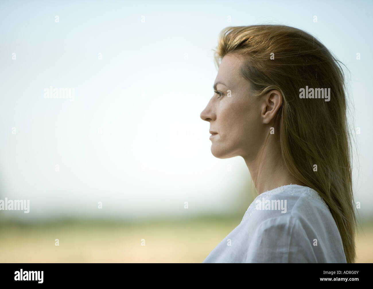 Woman outdoors, head and shoulders, profile Stock Photo