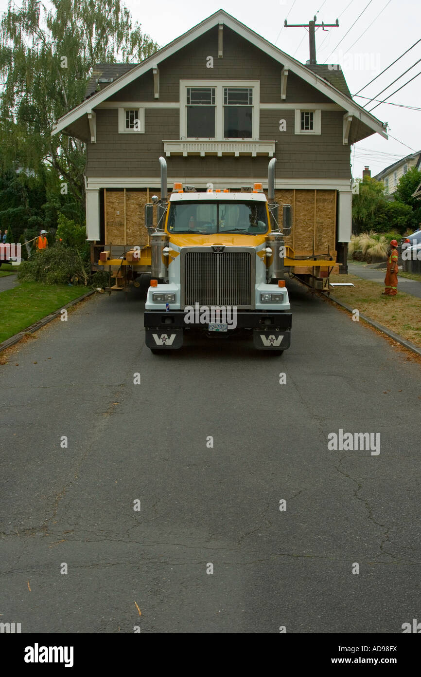 Full Sized House Moving down the Street Bought for a Dollar when Contractors Bought Land under it Seattle Washington Stock Photo