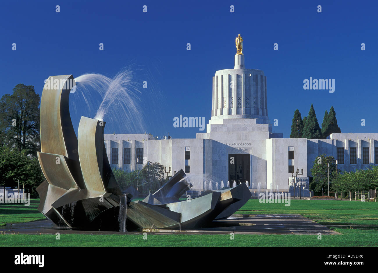 State Capitol building with gold Pioneer statue and water fountain