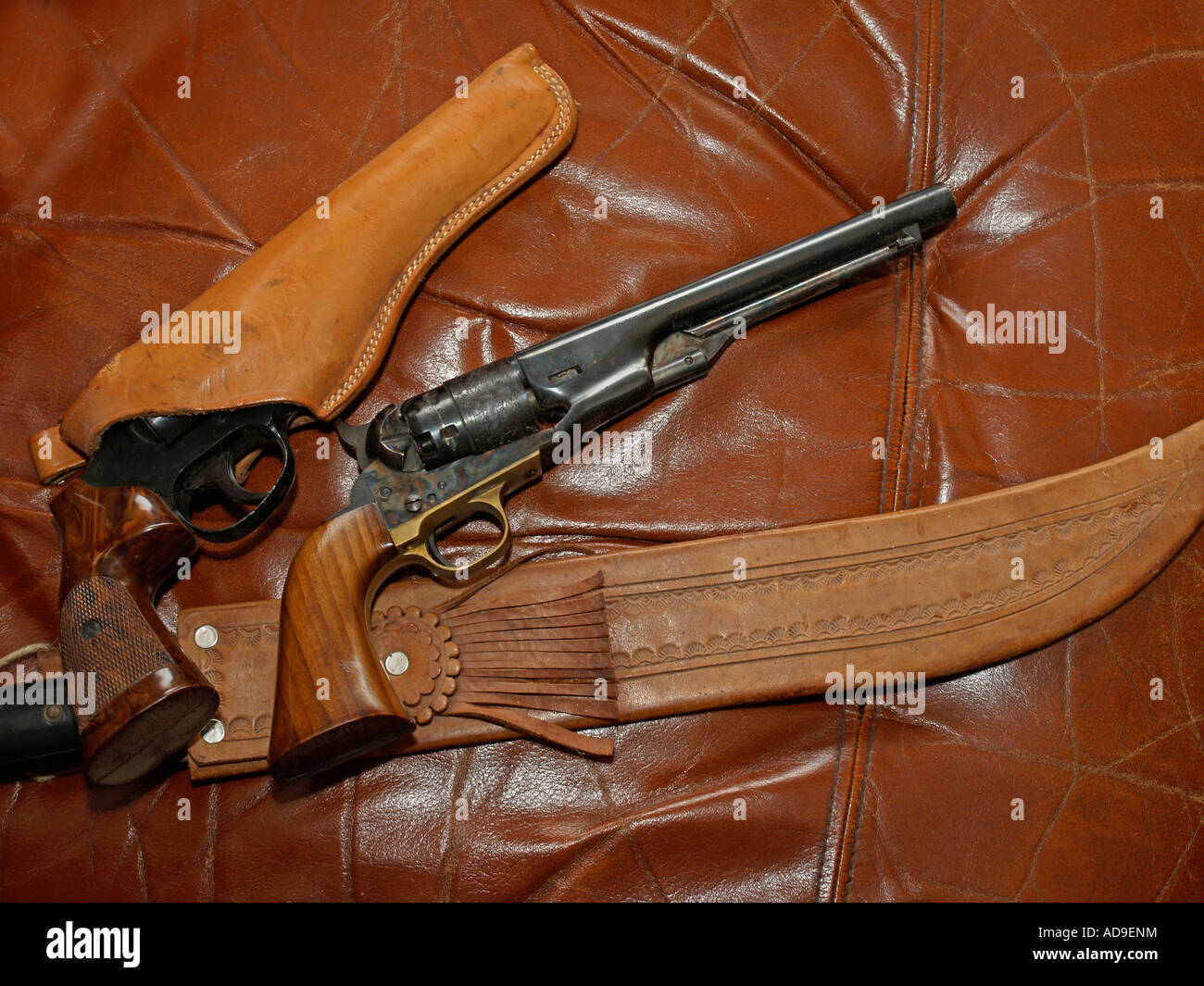 two guns and a machete knife on leather Stock Photo