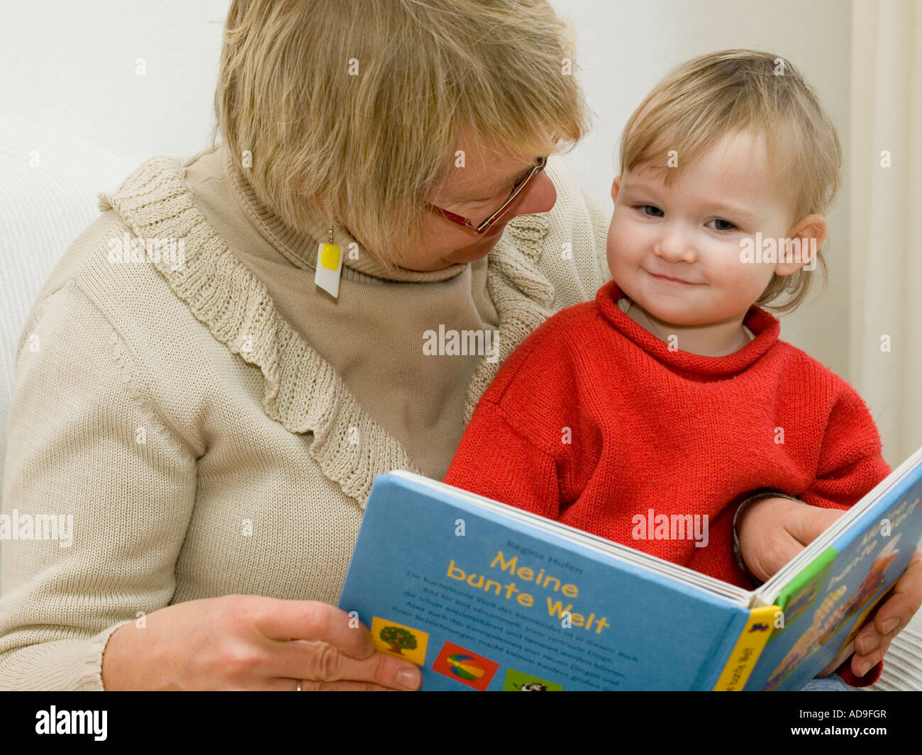 grandma reads book to baby