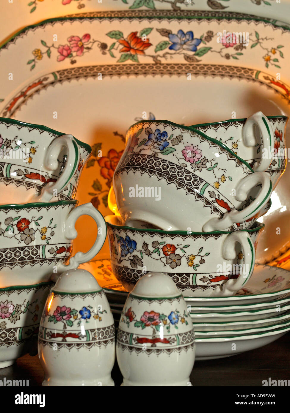 flowered crocery with soupe cups and plate in cupboard Stock Photo Alamy