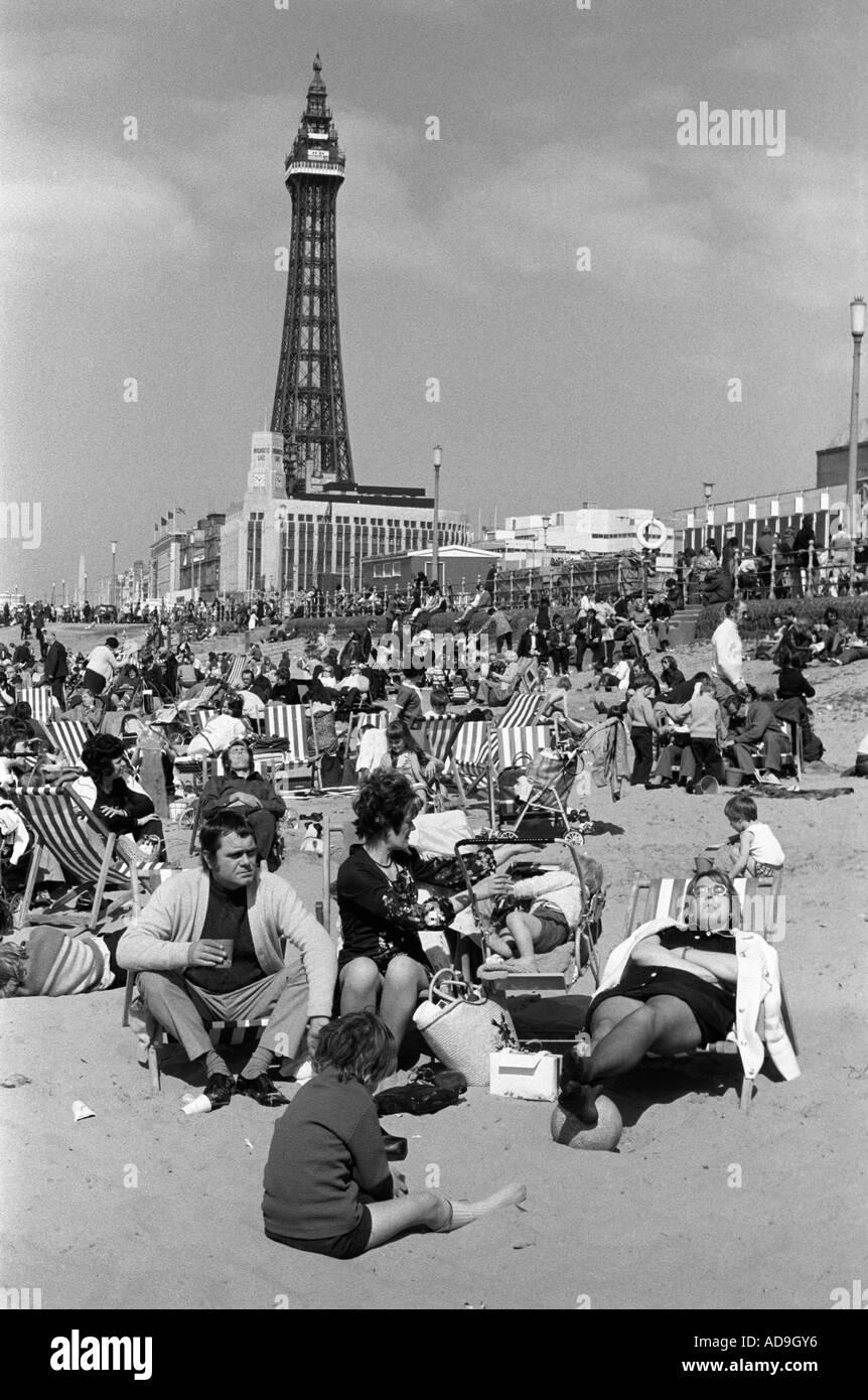 Blackpool Lancashire Uk circa August 1975. Blackpool Tower a famous landmark and summer sunshine, families gather on the beach. 1970s UK HOMER SYKES Stock Photo