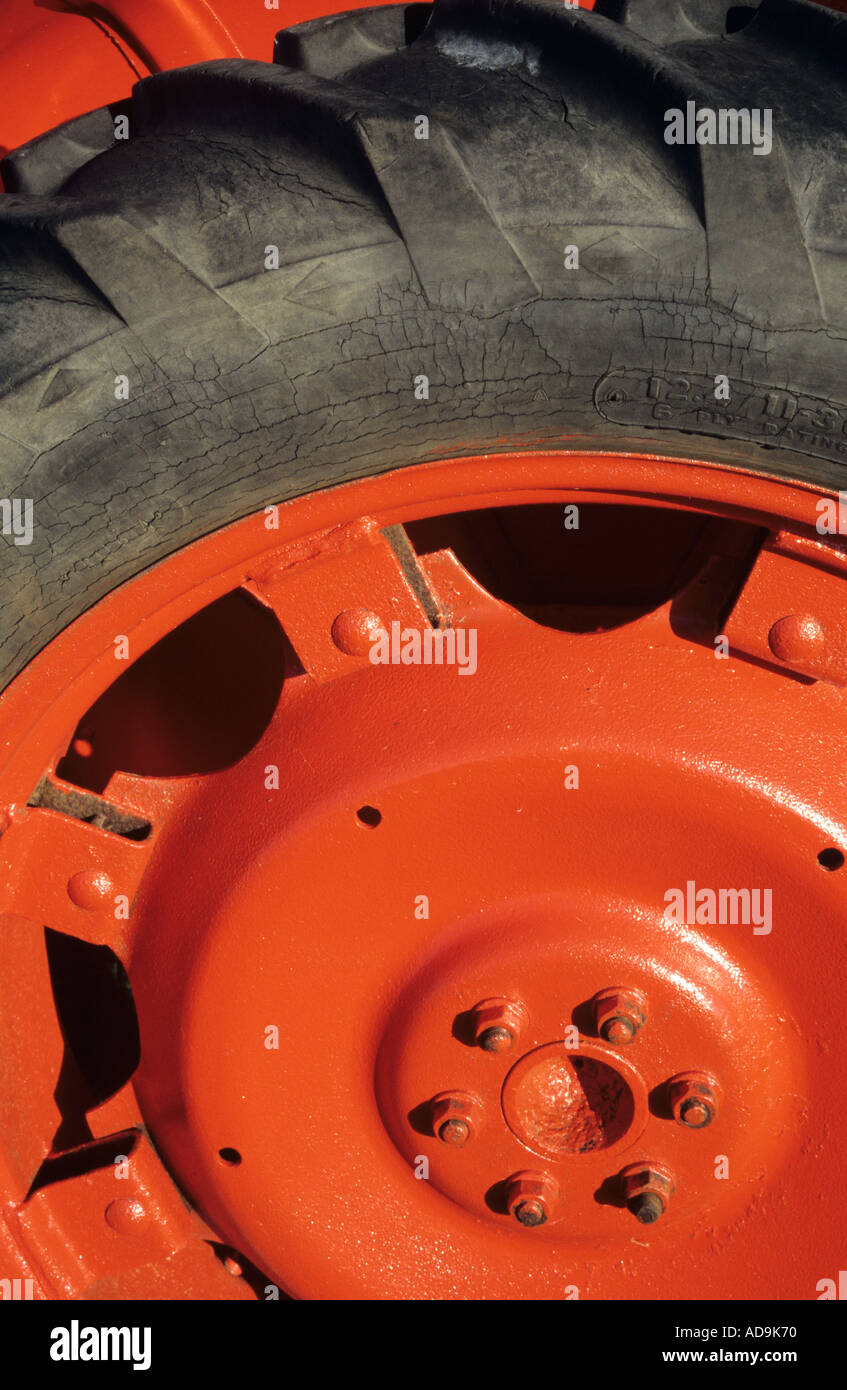 Detail of hub and tyre of an orange painted tractor Stock Photo