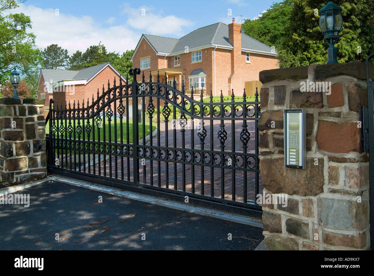 Security entrance electrically operated gate with intercom on a new and prestigious housing development Stock Photo