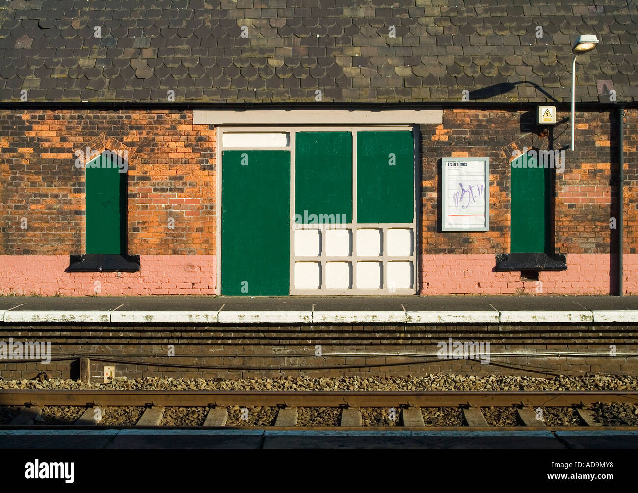 Building on Sankey for Penketh railway station platform which is boarded up to prevent vandalism Stock Photo
