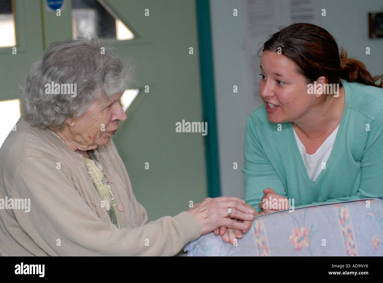 Care worker with elderly woman in home for people suffering from dementia, London, UK. Stock Photo