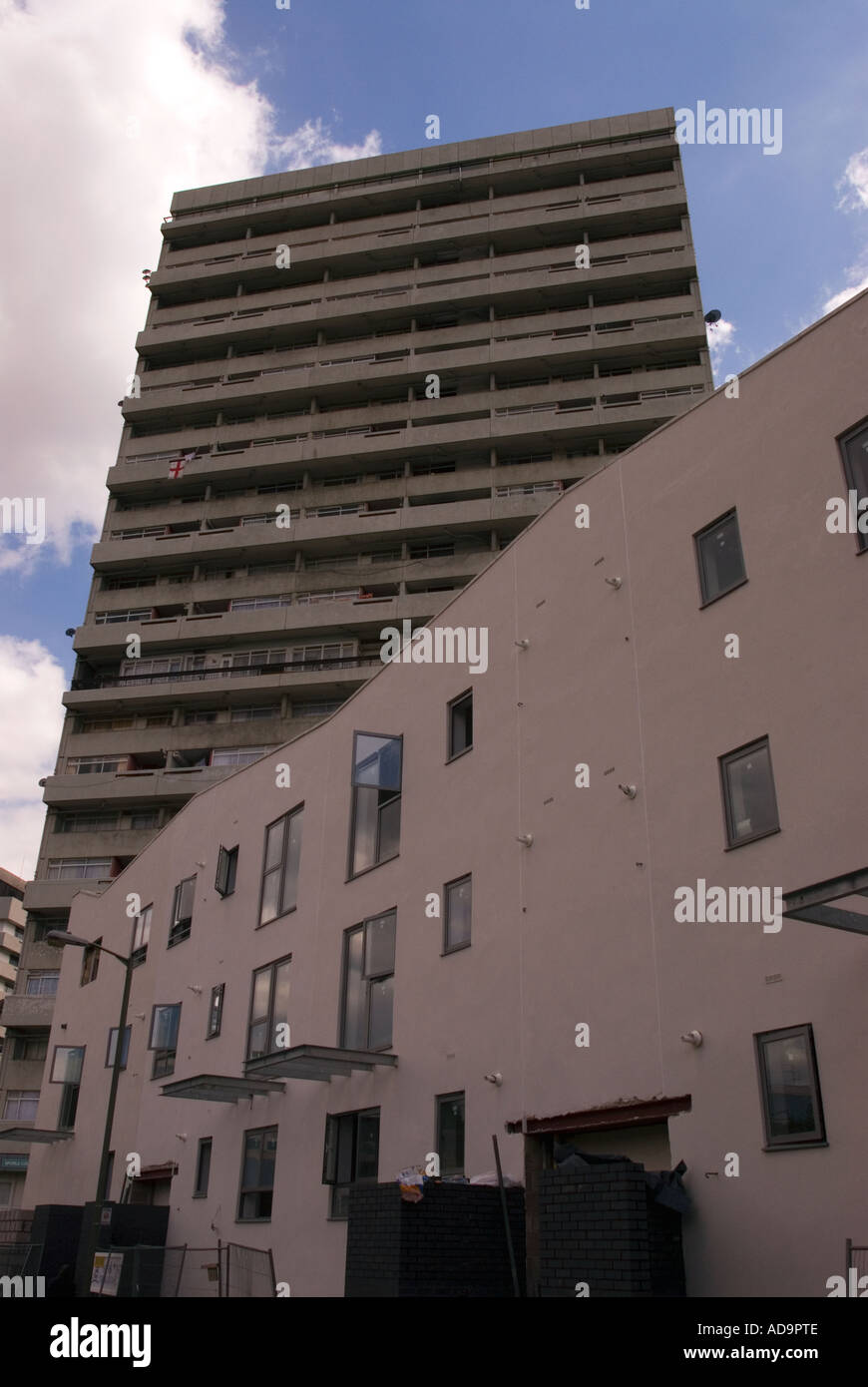 New housing development dwarfed by old style council tower block London UK Stock Photo