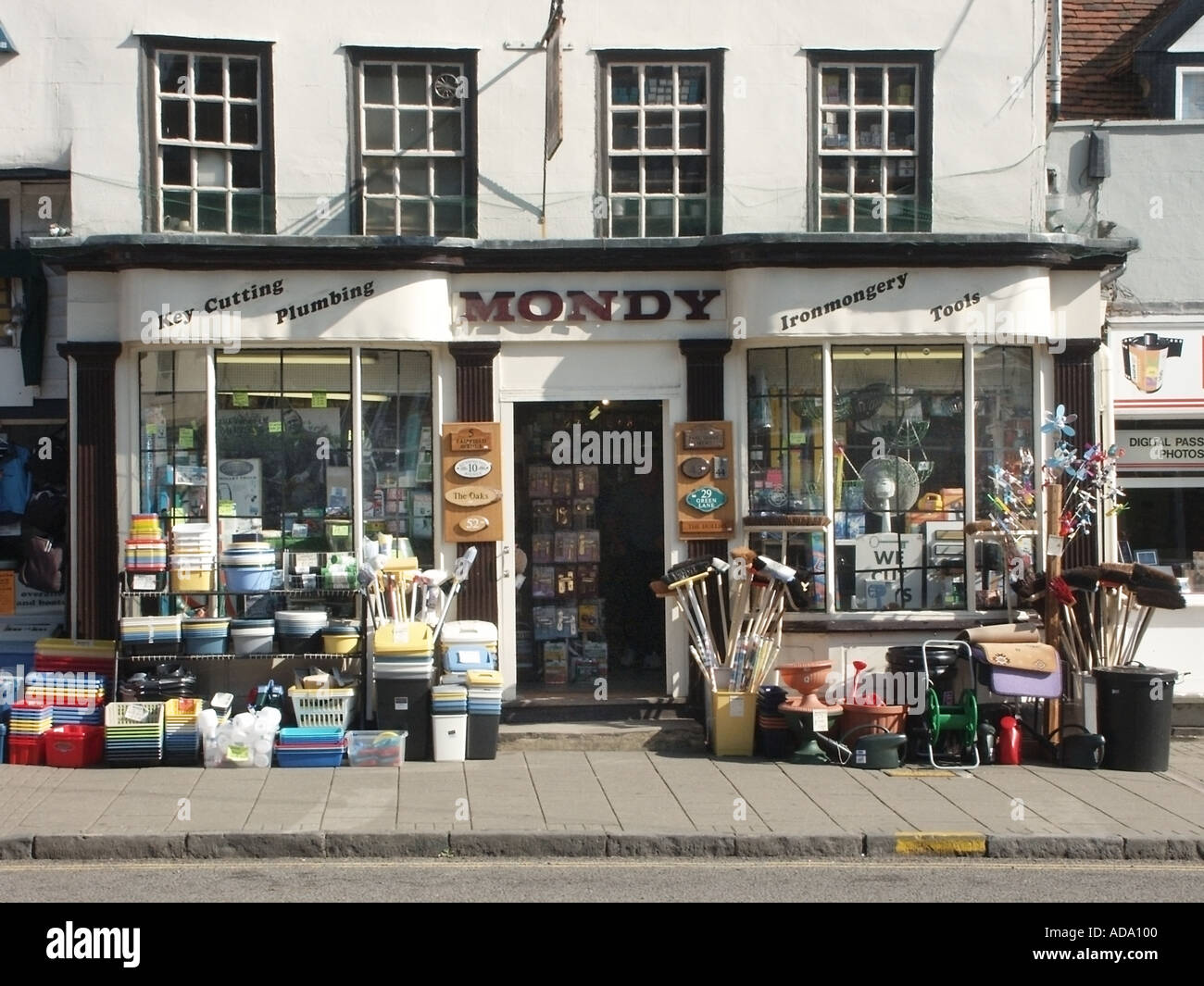 Shop front view traditional independent ironmongery store with goods & services for sale displayed on pavement and in windows Witham Essex England UK Stock Photo