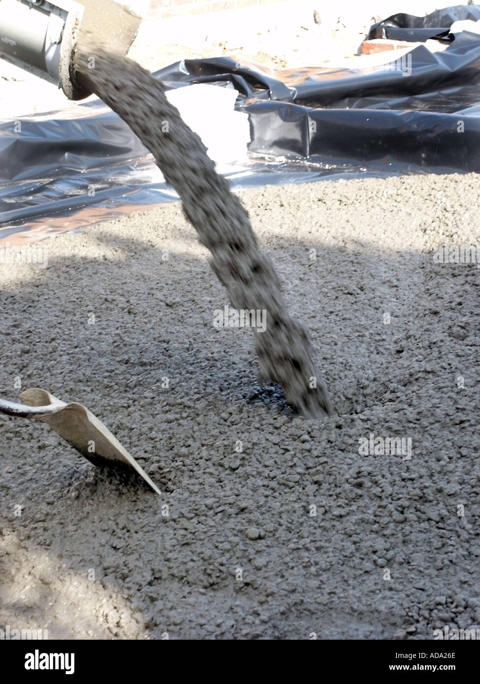 Ready mixed concrete truck unloading into ground floor slab foundation