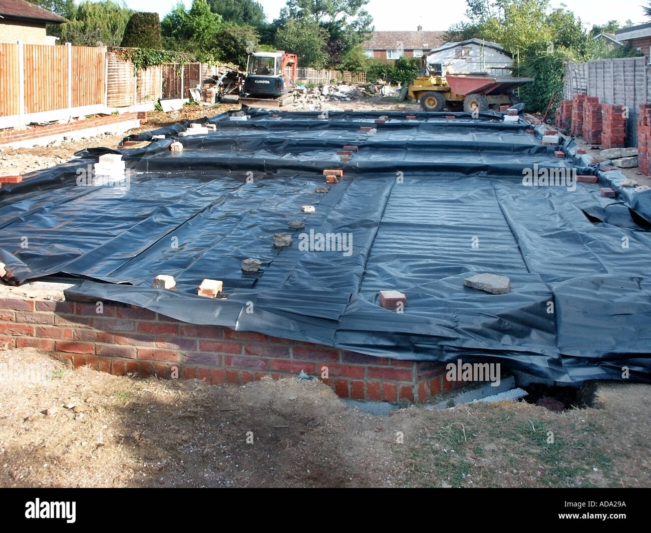 Plastic polythene sheet membrane to floor slab of new house building under construction awaiting concrete delivery to building site in England UK Stock Photo