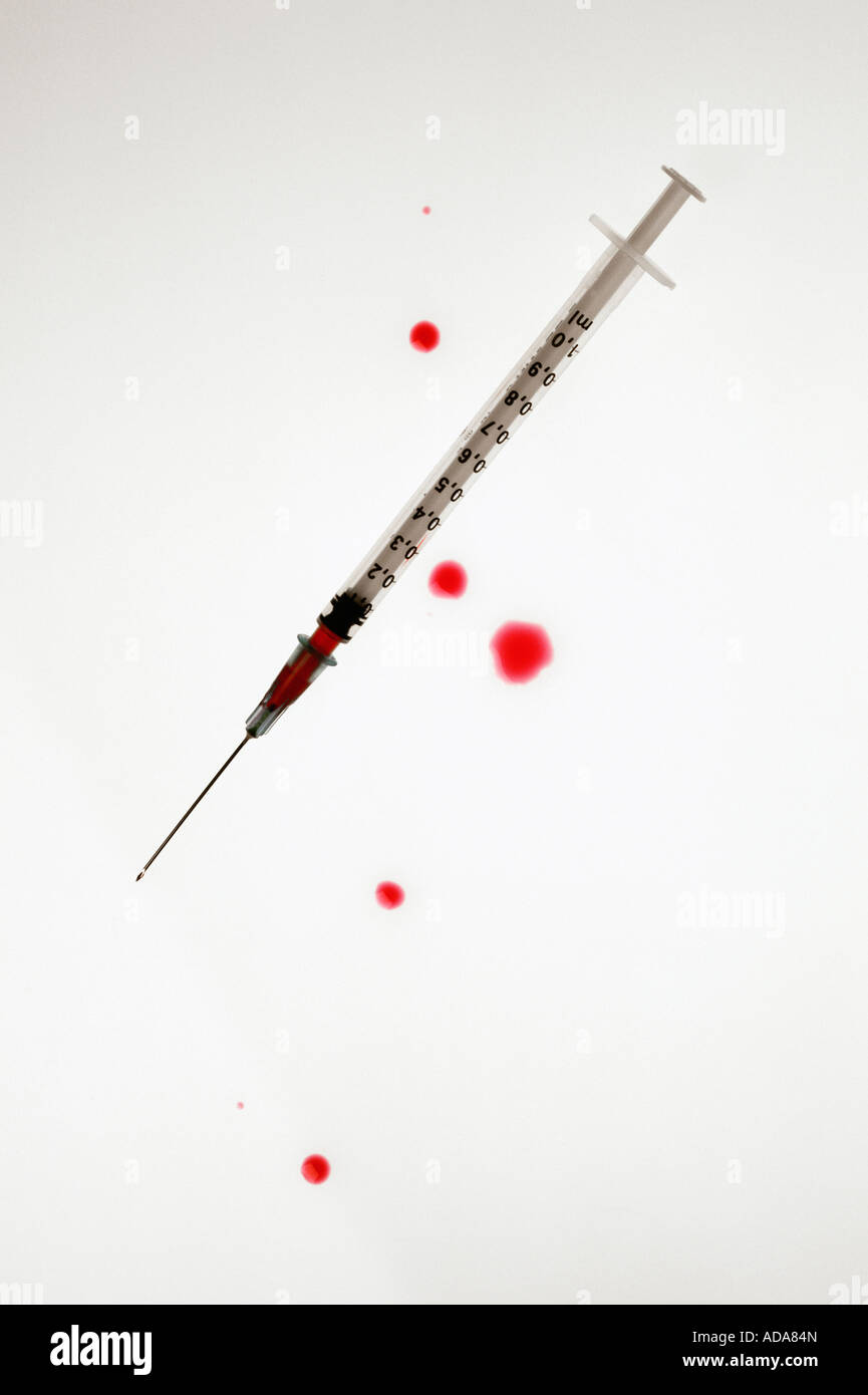Red blood spilt from syringe on white background Stock Photo