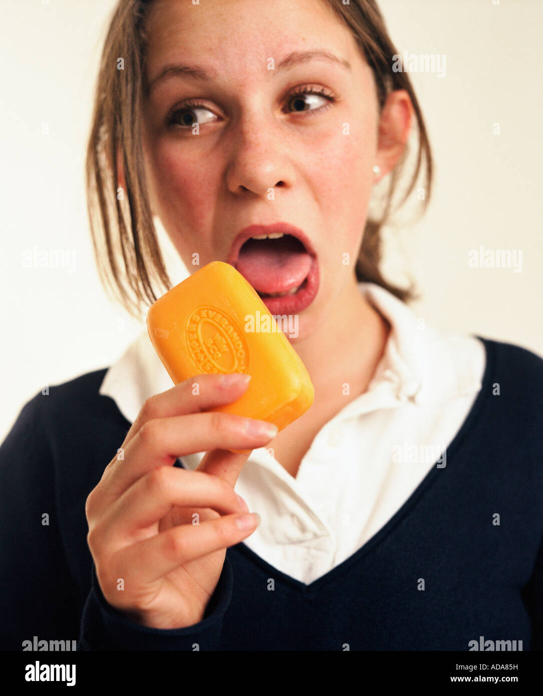Close-up of girl licking soap Stock Photo