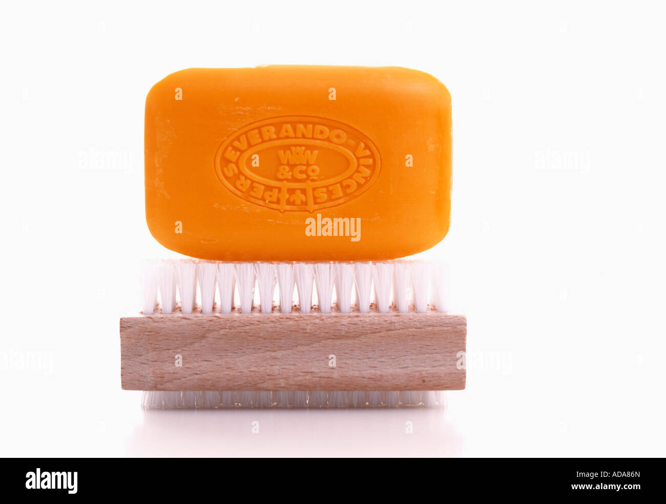 Soap and scrubbing brush on white background Stock Photo