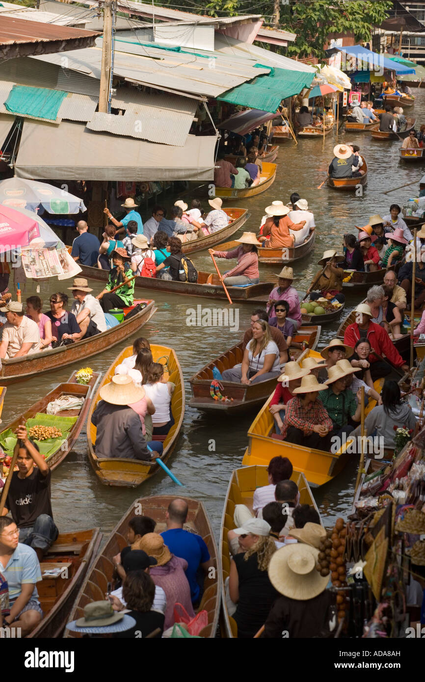 Tourists in a wooden boat visiting the Floating Market Damnoen Saduak near Bangkok Ratchaburi Thailand Stock Photo