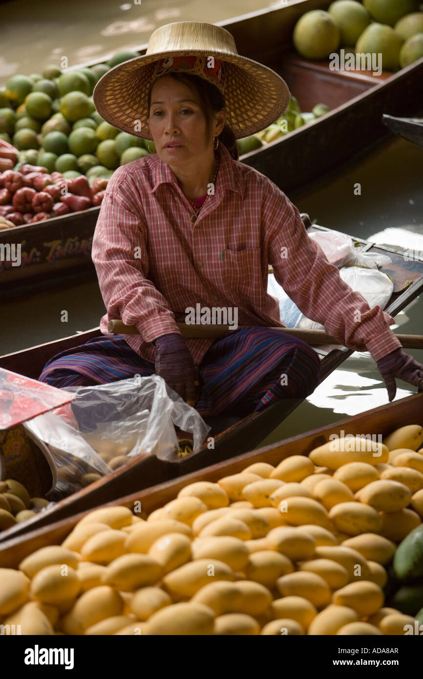 Woman offering fruits at Floating Market Damnoen Saduak near Bangkok Ratchaburi Thailand Stock Photo