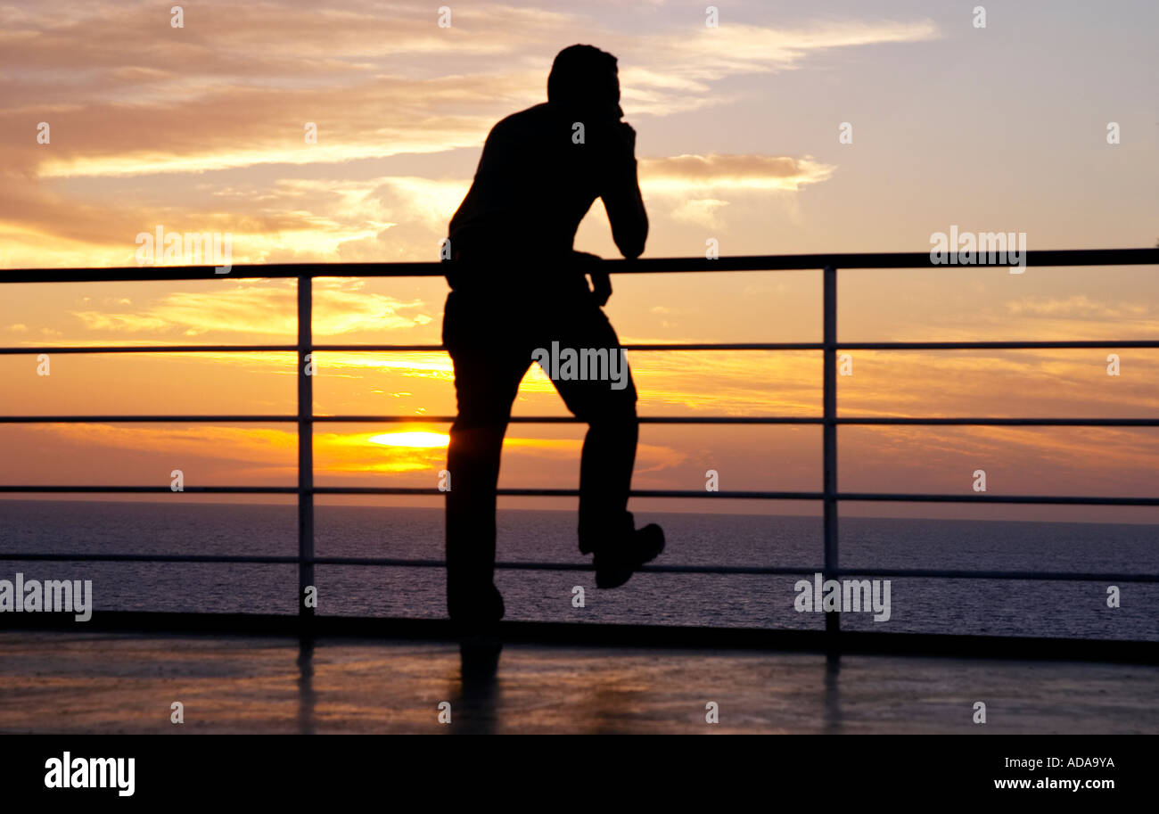 Thinking man silhouette and red sunset on a ferry Stock Photo