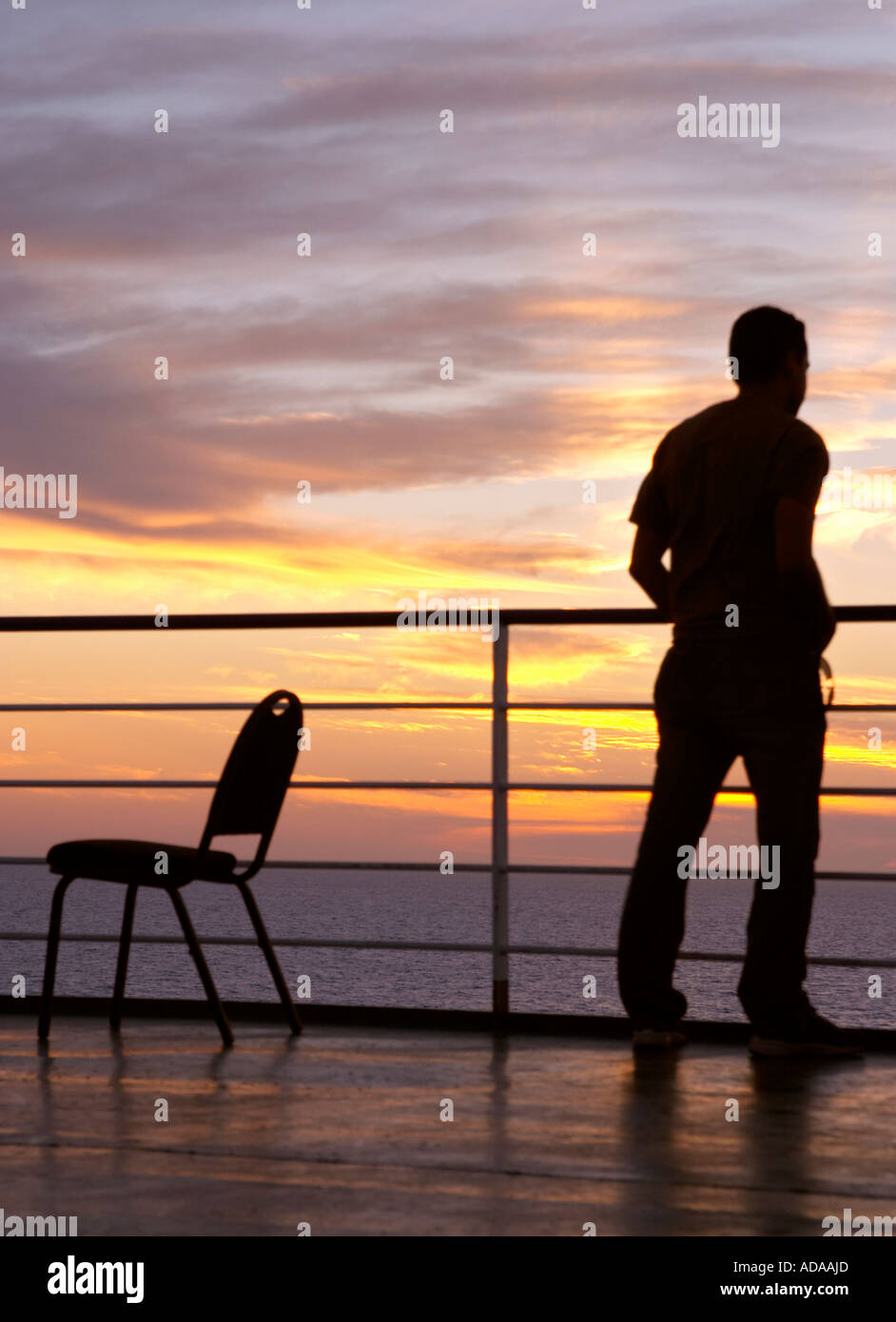 Man and chair black silhouette and sunset on a ferry Stock Photo