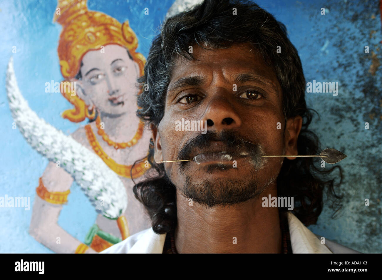 Kataragama a Hindu pilgrim perforating his face with an iron pin as a self chastisement ritual for the Hindu god Skanda Stock Photo