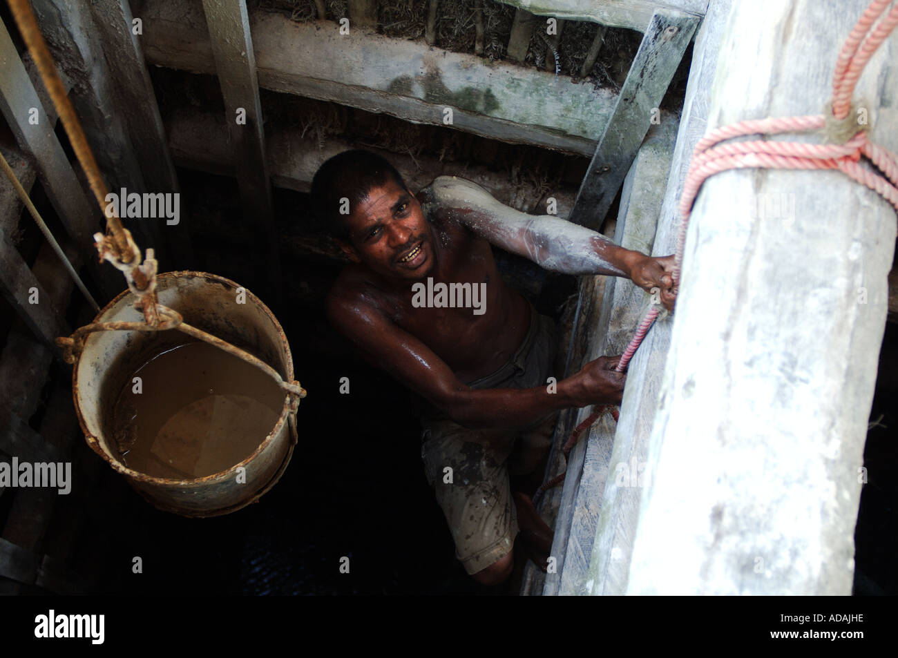 Kahawa miner climbing out of the shaft of a gem stone mine Stock Photo