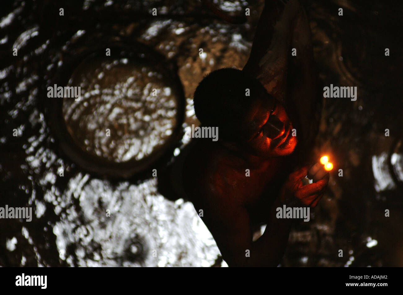 Kahawa miner at the bottom of the shaft of a gem stone mine Stock Photo
