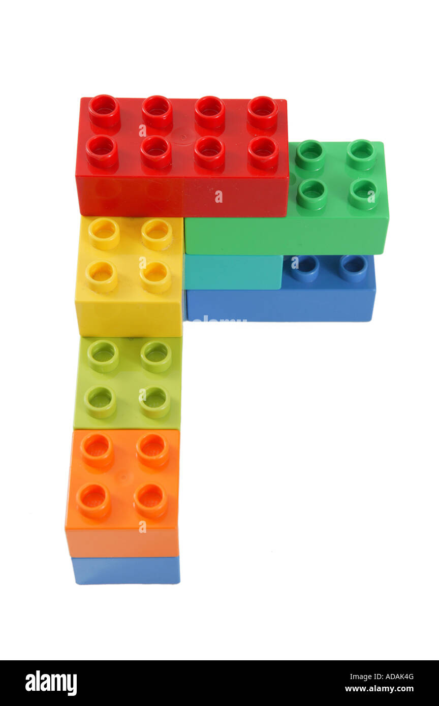 simple construction made from childs lego in studio on clean white surface involving blue orange yellow green and red colors Stock Photo