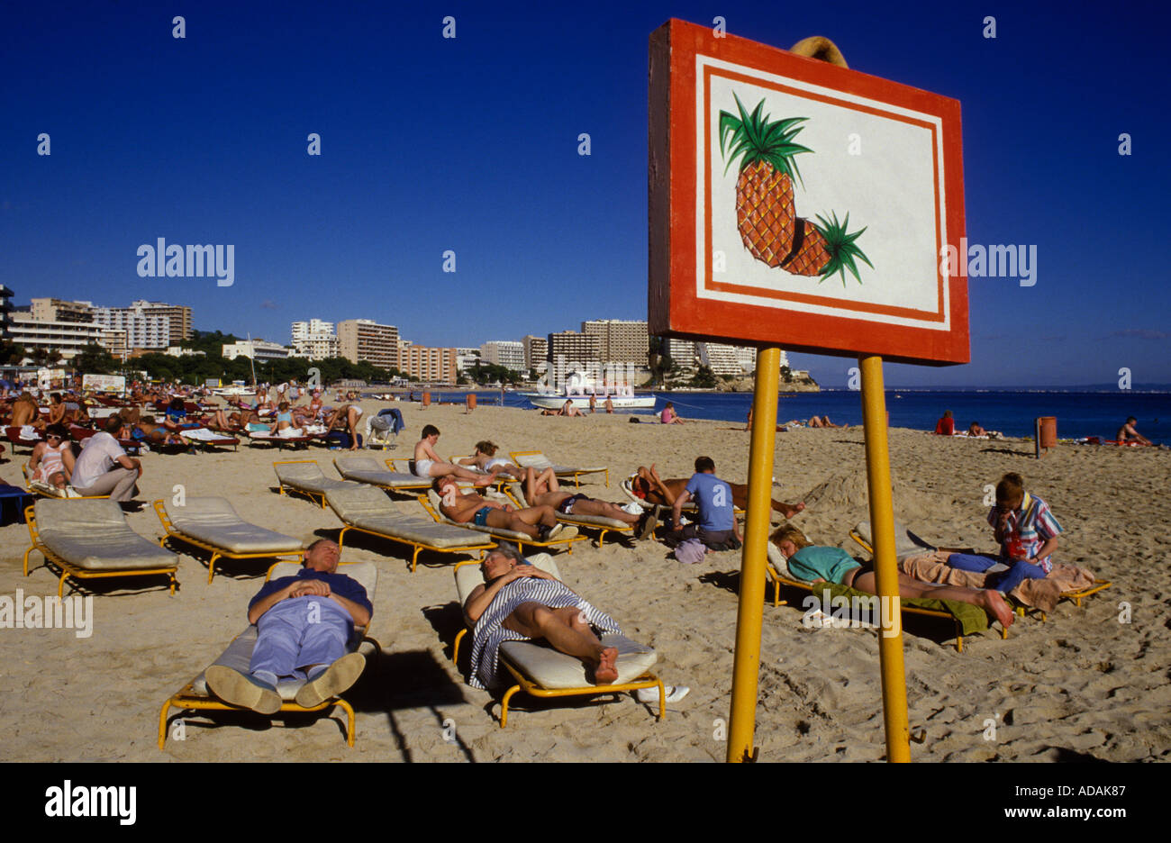 Palma Nova, Majorca Spain. Winter holiday Spanish sun for English old age pensioners. Sign to show where you are positioned on beach 1980s HOMER SYKES Stock Photo
