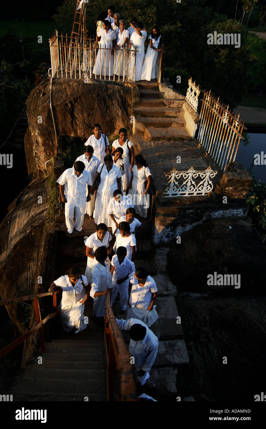 Anuradhapura buddhist pilgrims visit the Isurumuniya Vihara pagoda site at sunset Stock Photo