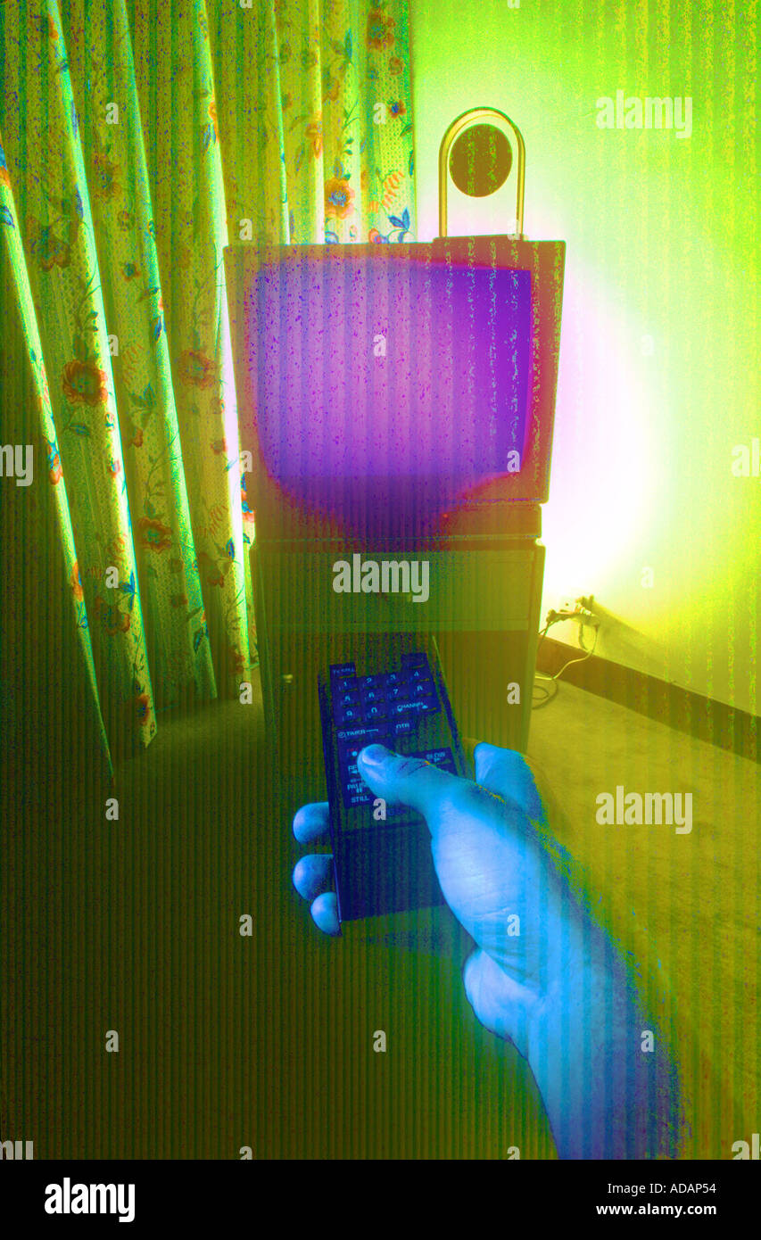 Hand Holding TV Remote Control In Surreal Setting Stock Photo Alamy