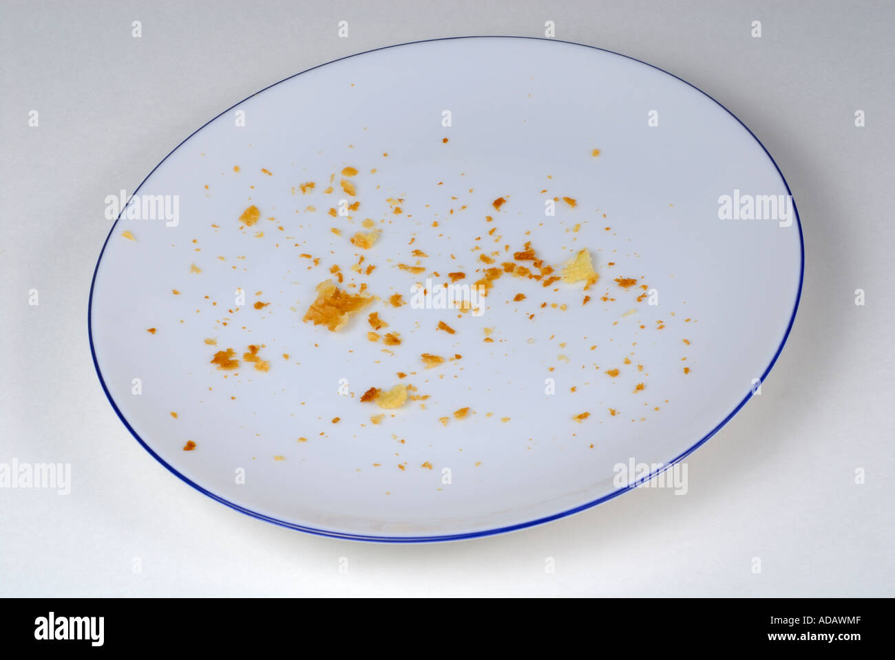 Crumbs on an empty plate Stock Photo