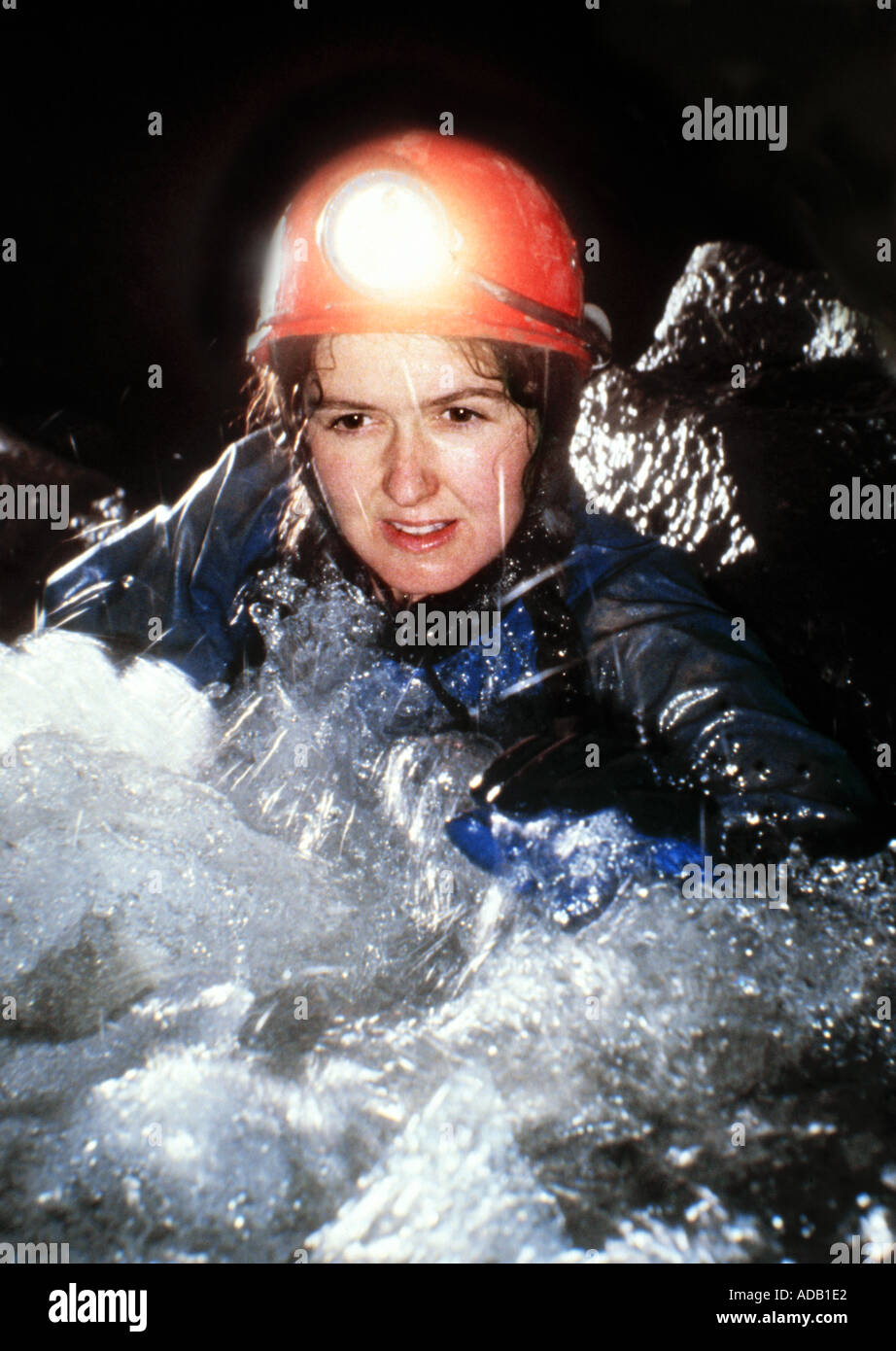 Female caver in water Wales UK Stock Photo