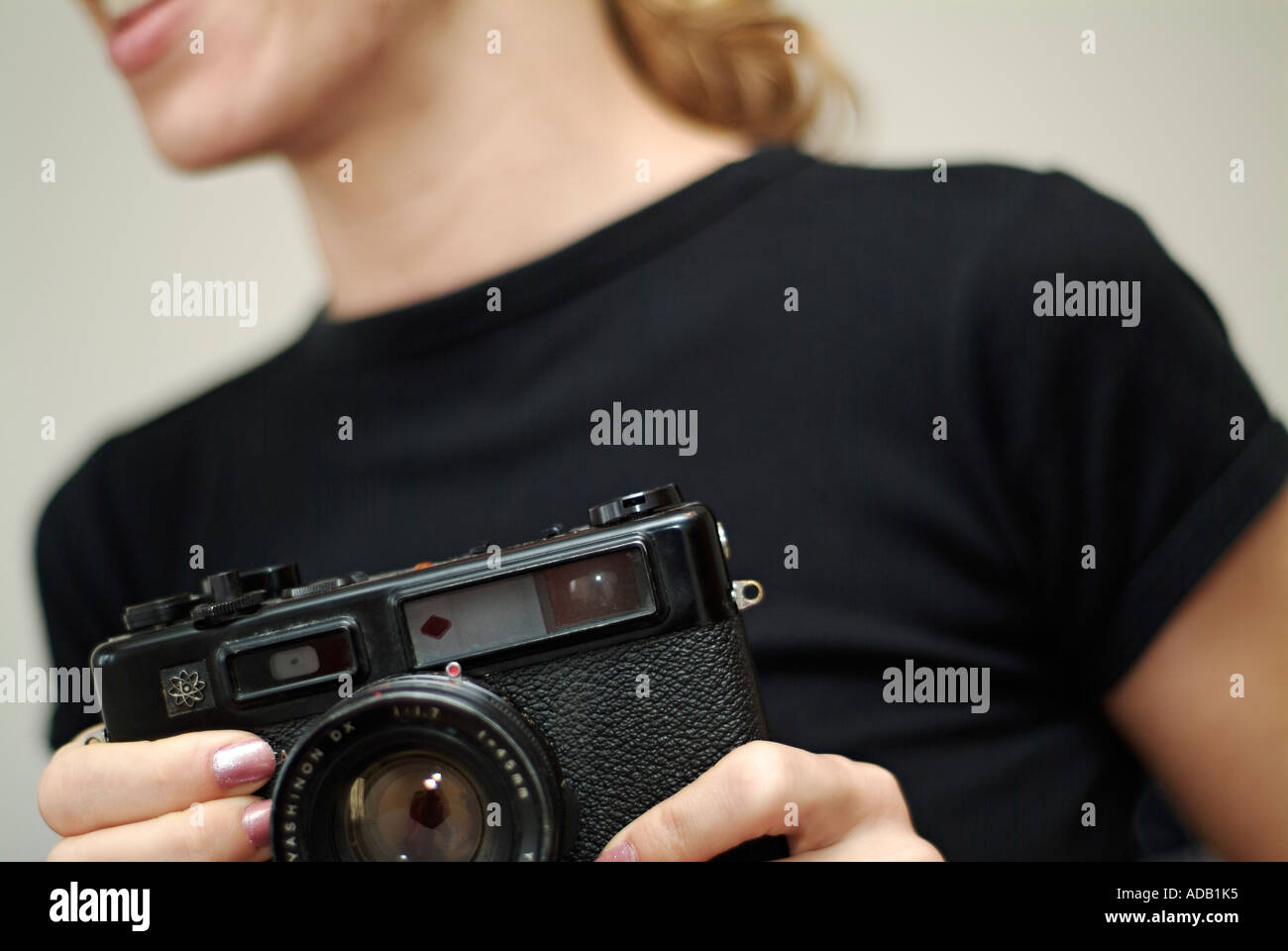 Abstract of Young Caucasian Female using a Classic Rangefinder Camera Stock Photo