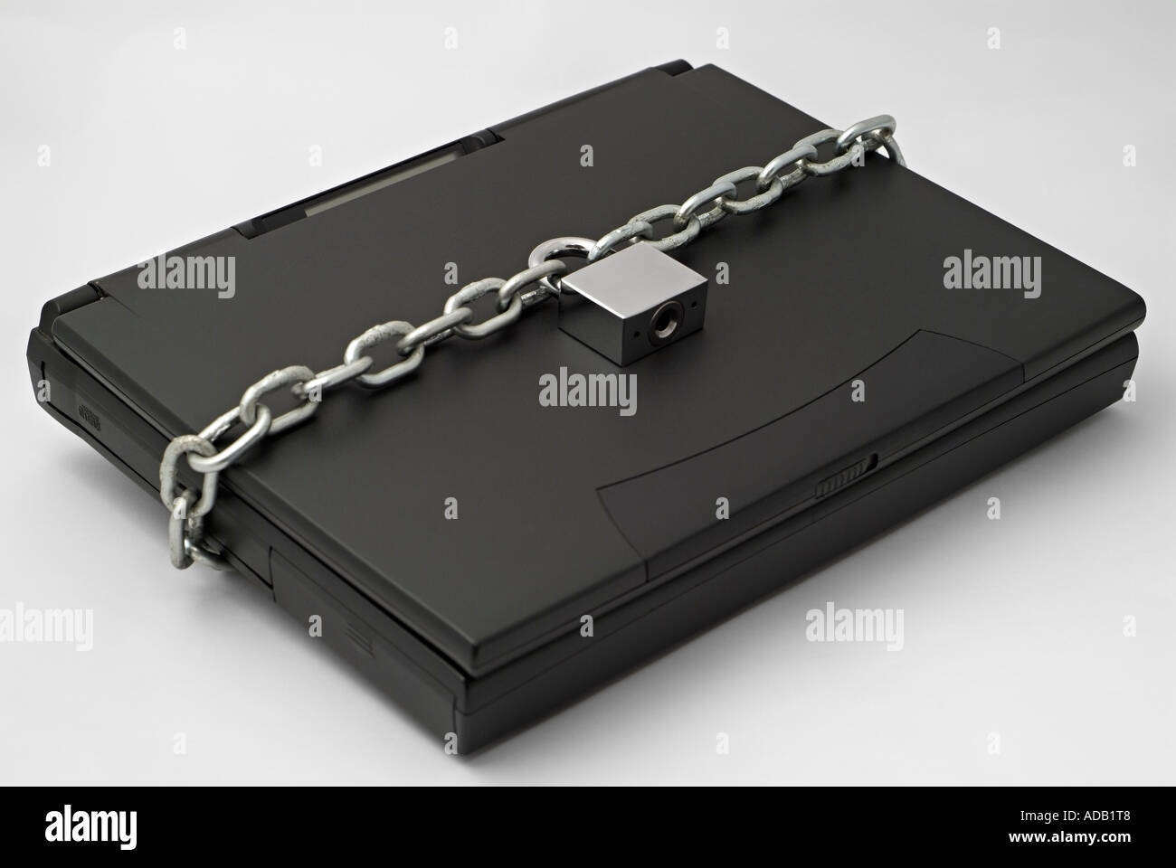 Chain and Padlock Securing a Laptop Computer Stock Photo