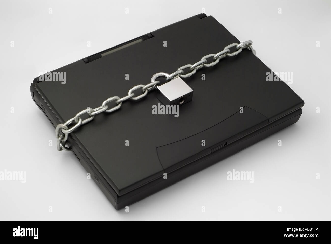 Chain and Padlock Securing a Laptop Computer Stock Photo