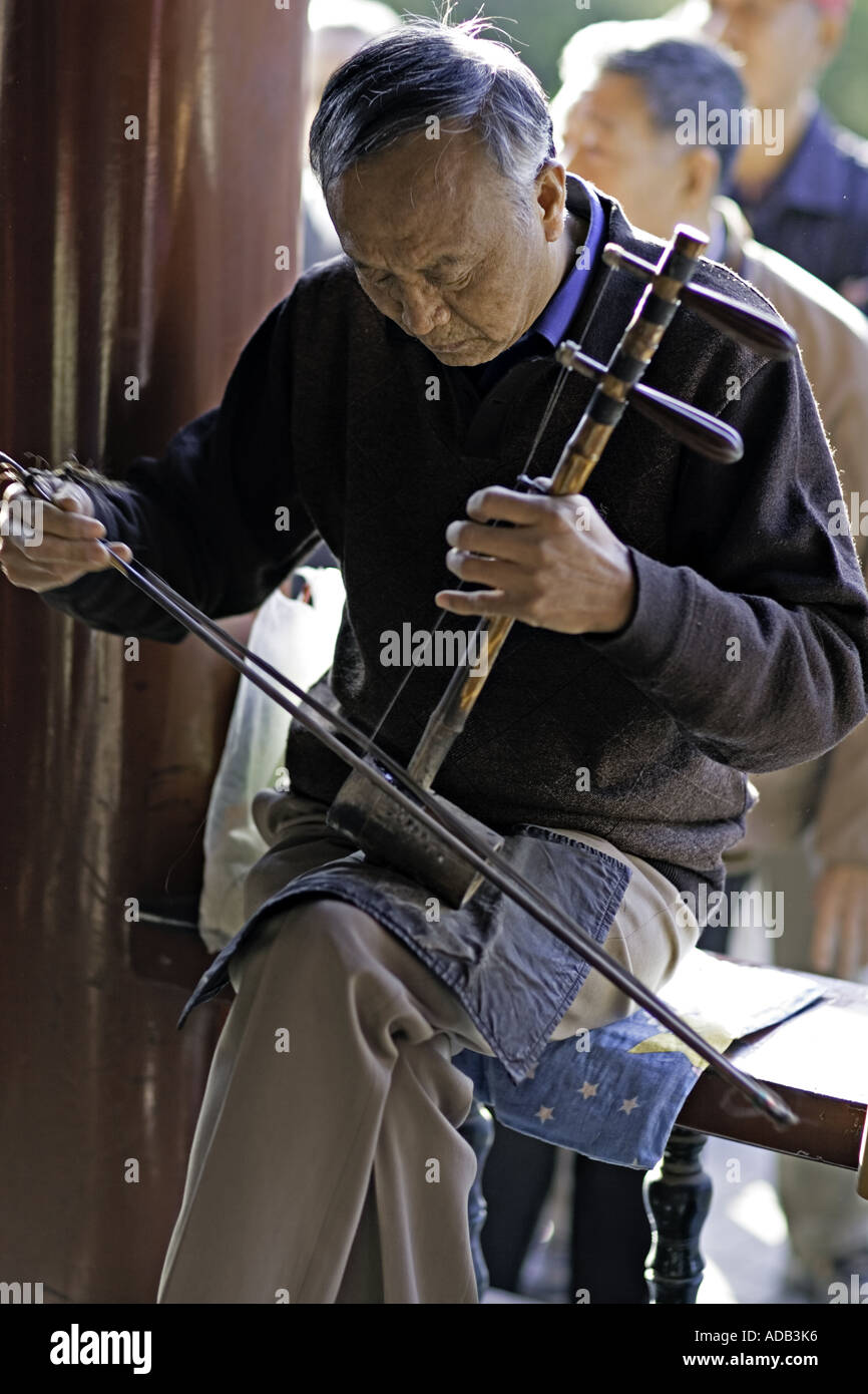 CHINA BEIJING Elderly Chinese gentleman playing the two stringed erhu at the Temple of Heaven Park Stock Photo