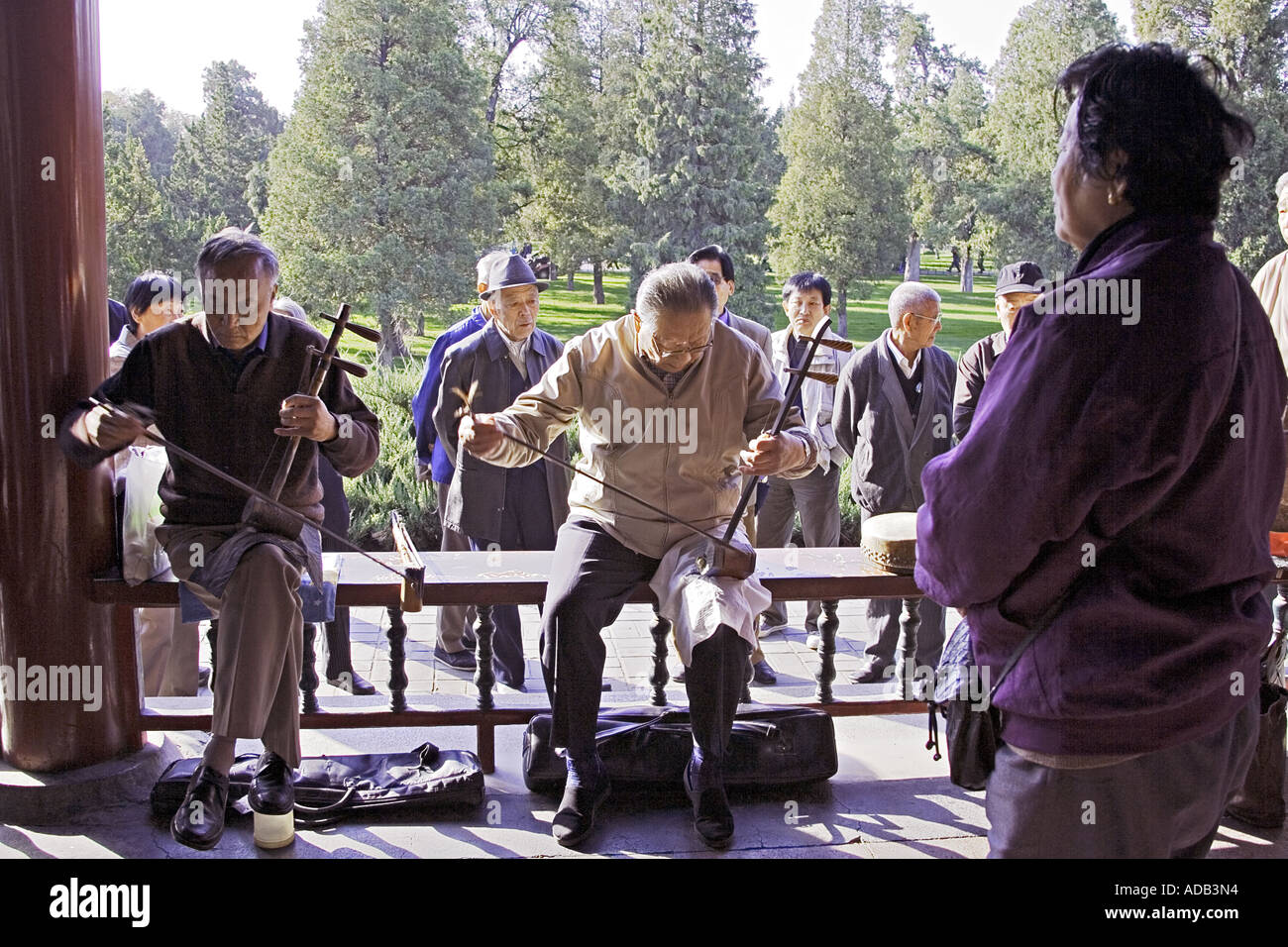 CHINA BEIJING Two elderly Chinese gentlemen playing the two stringed erhu at the Temple of Heaven Park Stock Photo