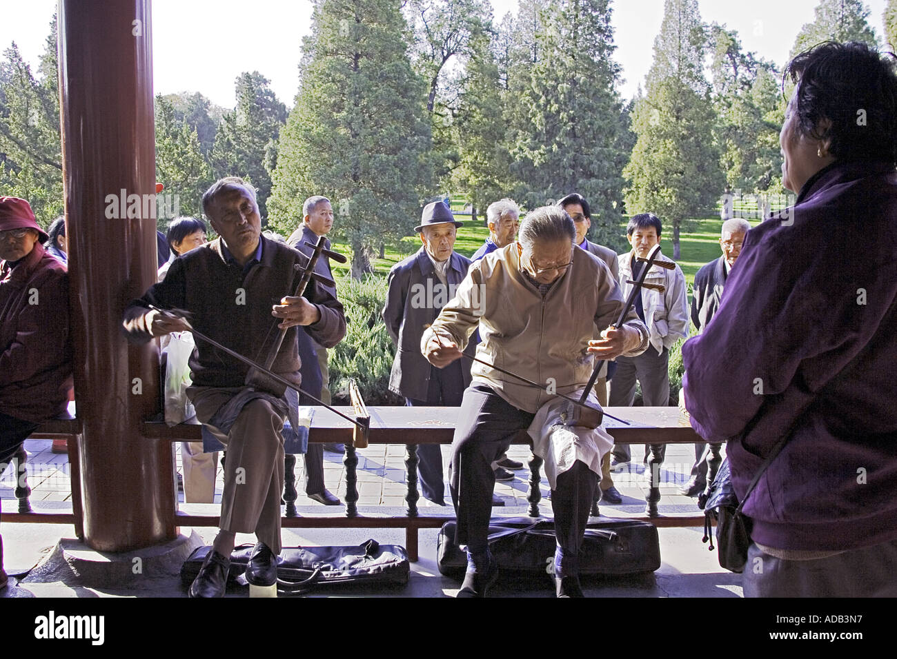 CHINA BEIJING Two elderly Chinese gentlemen playing the two stringed erhu at the Temple of Heaven Park Stock Photo