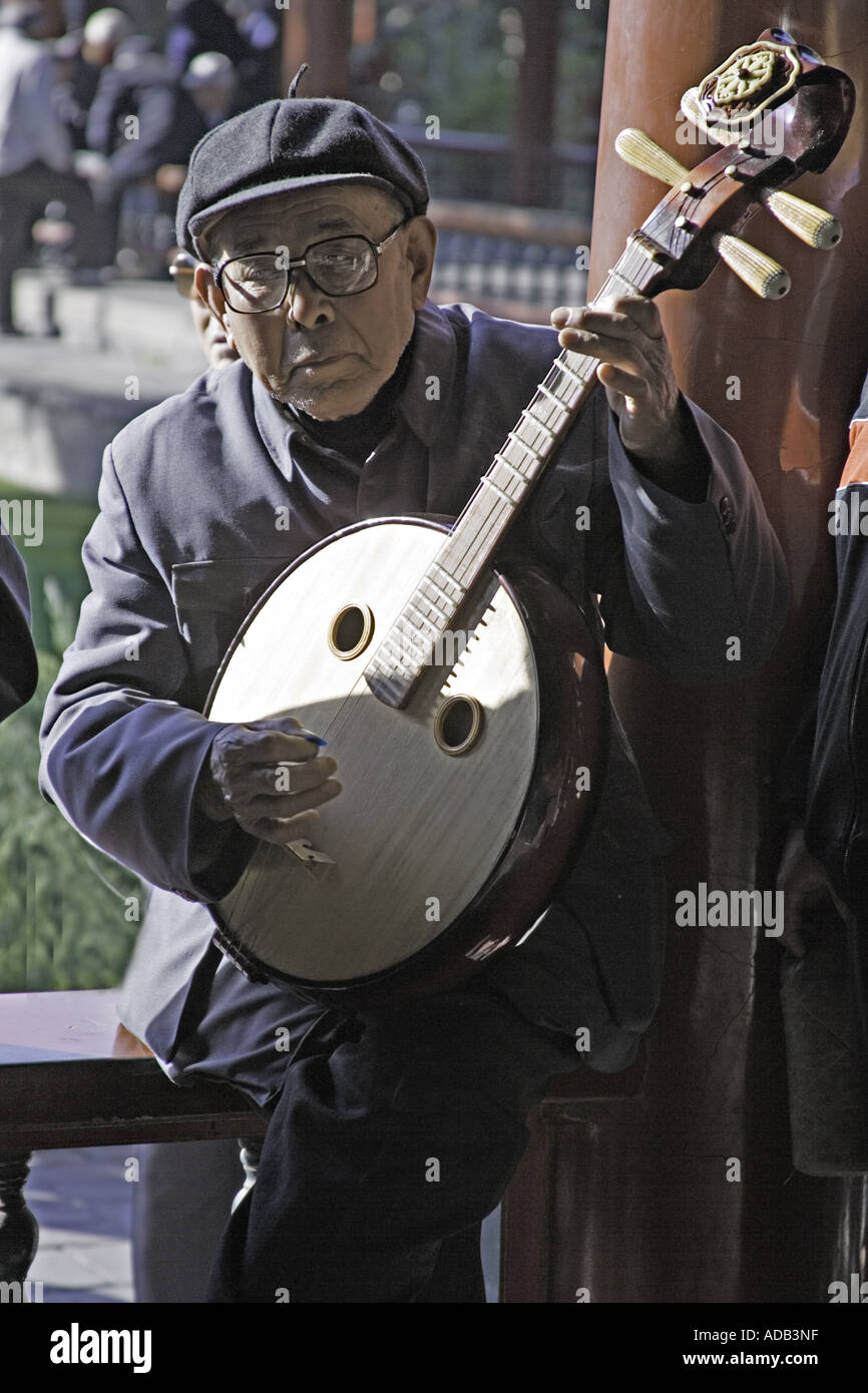 CHINA BEIJING Elderly Chinese gentleman playing the four stringed pipa at the Temple of Heaven Park Stock Photo