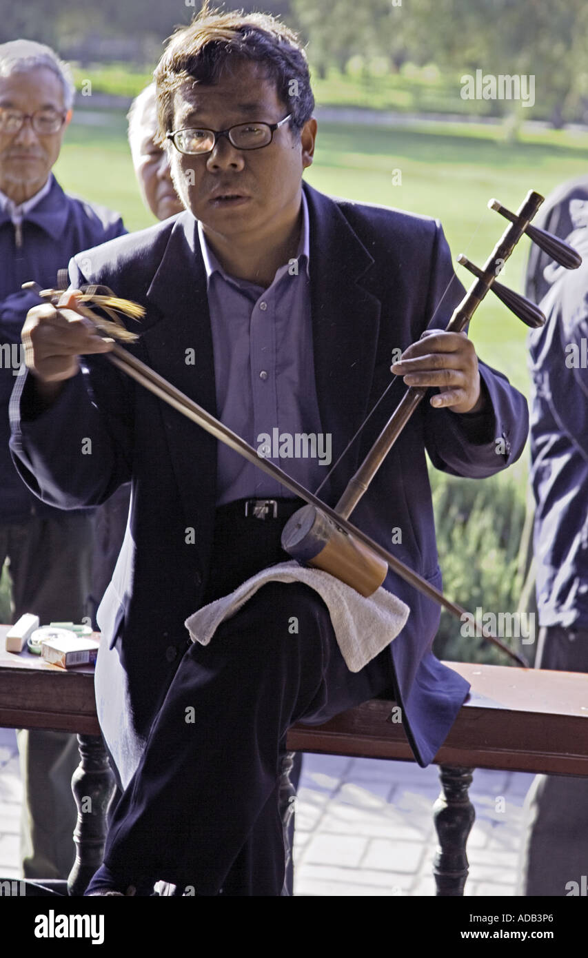 CHINA BEIJING Elderly Chinese gentleman playing the two stringed erhu at the Temple of Heaven Park Stock Photo