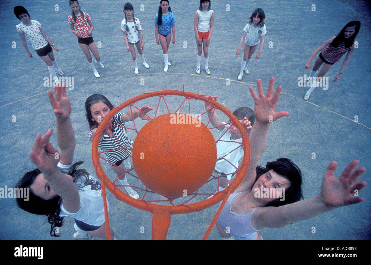 Girls playing netball in a primary school playground in the UK Stock Photo